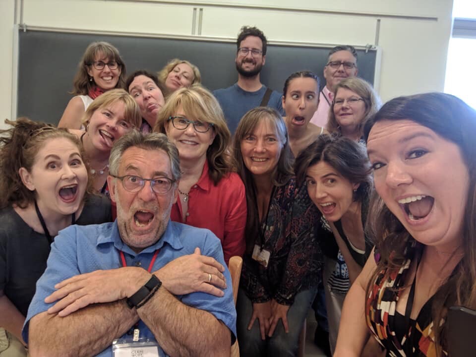 sixteen adults making silly faces