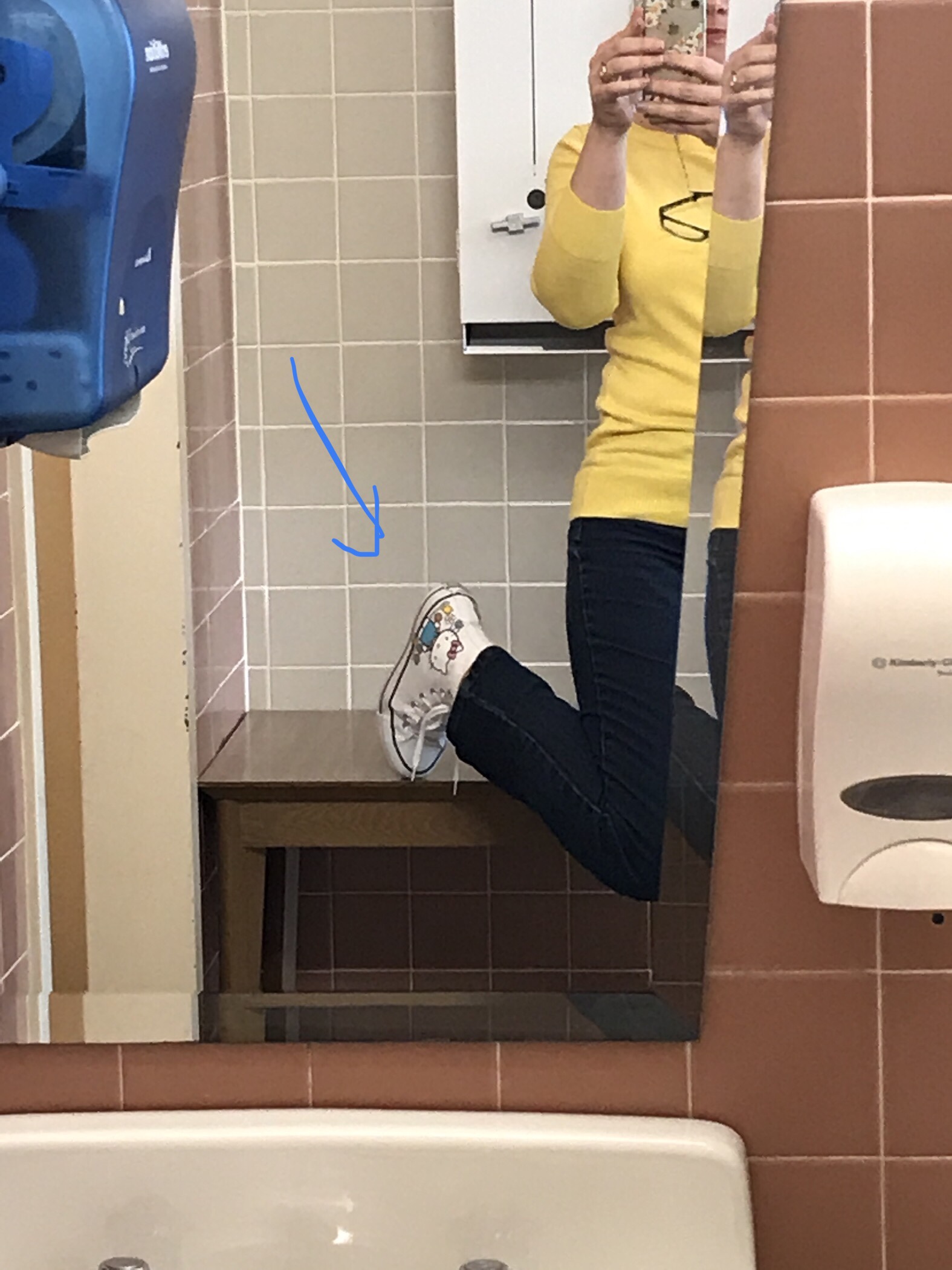 kimbol showing off new Hello Kitty Converses via the school-bathroom mirror