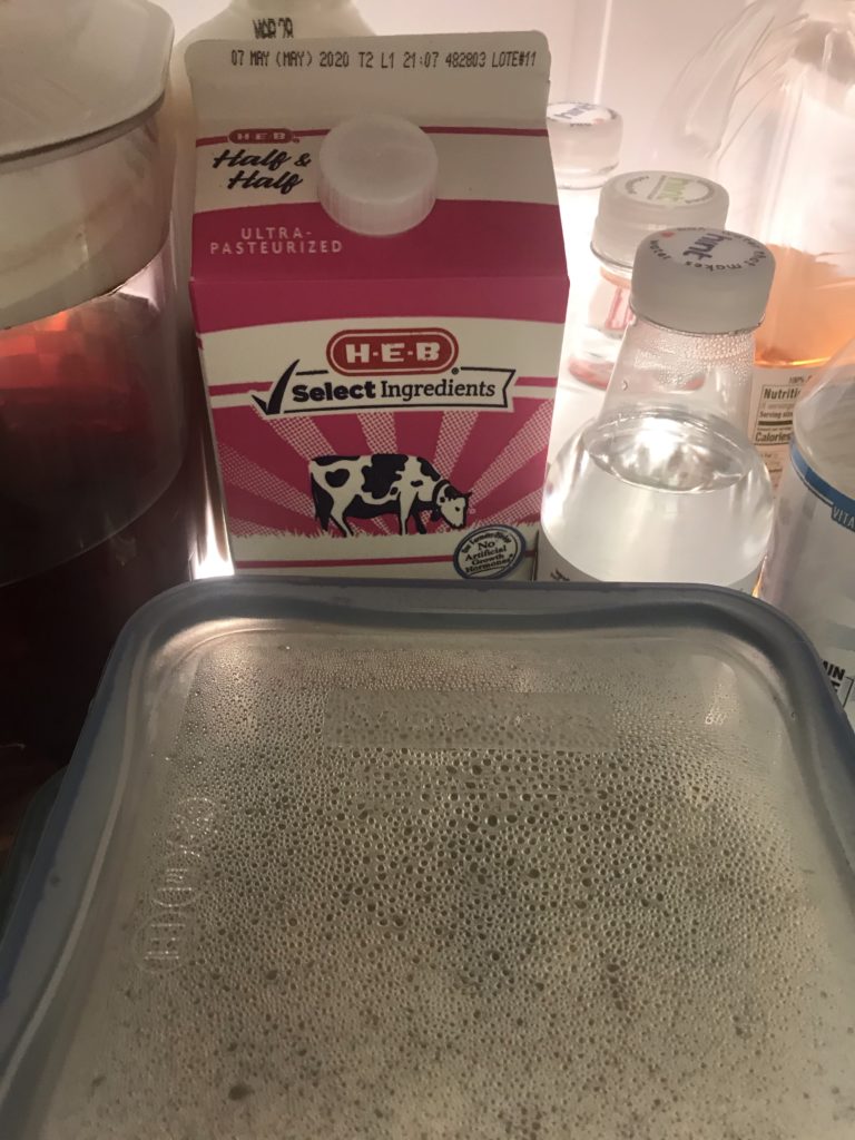 Still lifA Half-gallon of coffee cream, amid beverages and leftovers